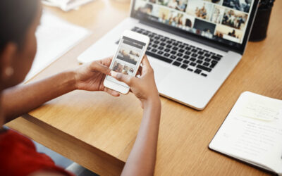 Woman using phone and laptop